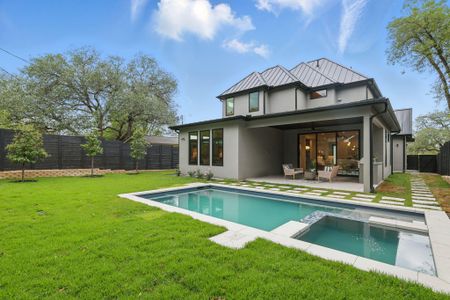 Back of house featuring an outdoor living space, a fenced backyard, stucco siding, a pool with connected hot tub, and a patio