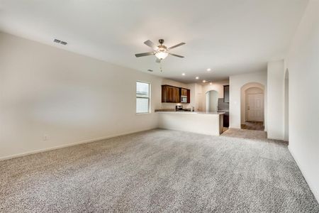 Living room featuring light colored carpet and ceiling fan