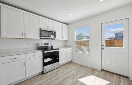 Airy kitchen with large island *real home pictured