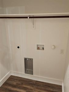 Laundry area with wood-type flooring, hookup for a washing machine, gas dryer hookup, and electric dryer hookup