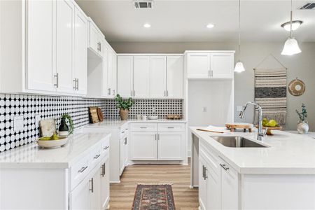 Bright and welcoming, this kitchen offers a large island, perfect for cooking or gathering, paired with a cozy breakfast nook for your morning coffee.