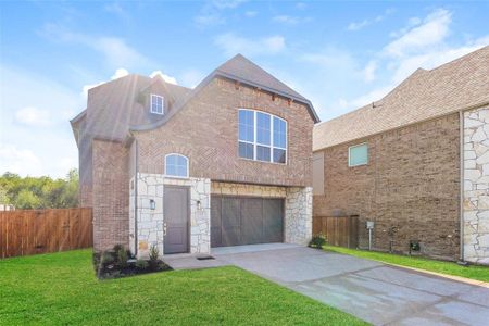 View of front of property featuring a garage and a front yard