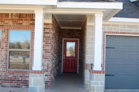 View of exterior entry with a garage