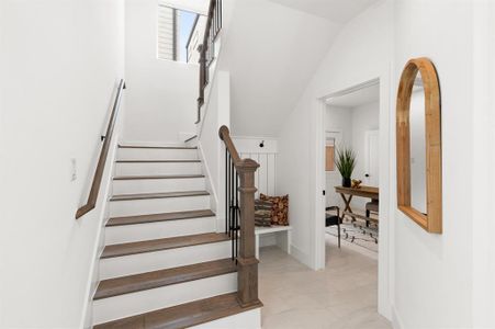 The stunning entryway features a charming mud section and leads to the first bedroom on the first floor.