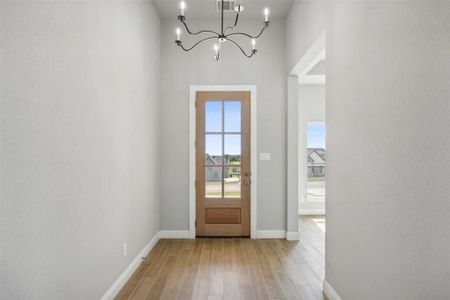 Foyer featuring a chandelier and light wood-type flooring