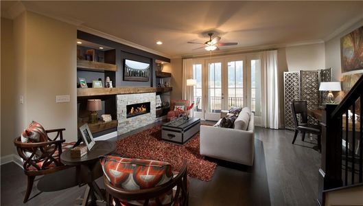 The family room with double doors lead to covered porch on front of home. Photos are NOT of actual home, but a previously built Sherwood.