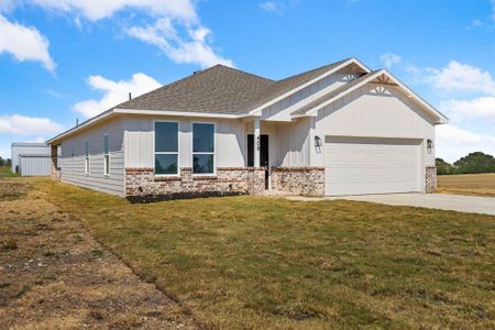 View of front of home featuring a garage and a front lawn