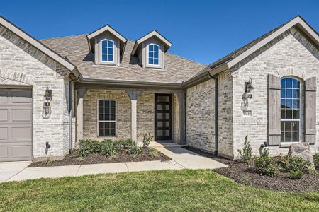 View of front of home featuring a garage and a front lawn