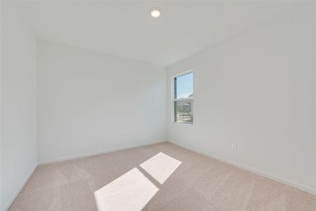 Spare room with light colored carpet