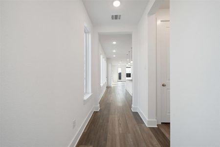 Hall with dark hardwood / wood-style flooring