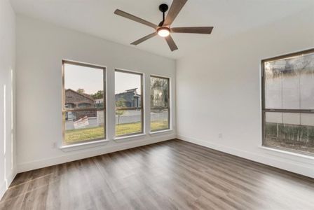 Spare room featuring hardwood / wood-style flooring and ceiling fan