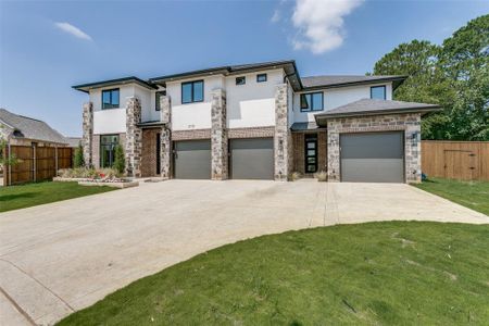 View of front of house with a front yard and a garage