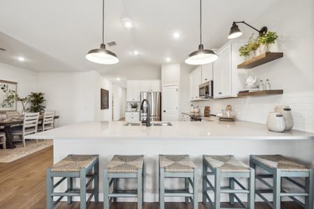 Kitchen with pendant lighting and floating shelves