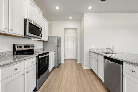 Whirlpool kitchen appliances and granite countertops make this kitchen chef-ready!