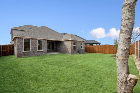 Rear view of property with a yard covered patio and privacy fence.