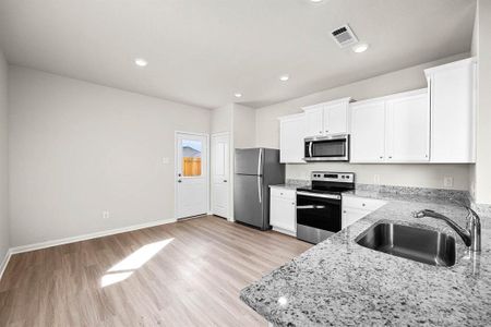 Whirlpool appliances and granite countertops make this kitchen chef-ready.