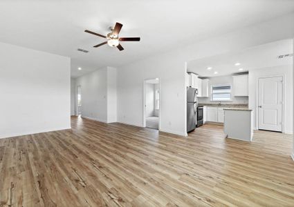 The foyer leads into the family room and adjoining kitchen