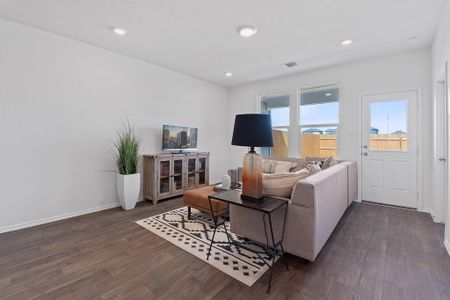 Living room featuring dark wood-style flooring, recessed lighting, visible vents, and baseboards