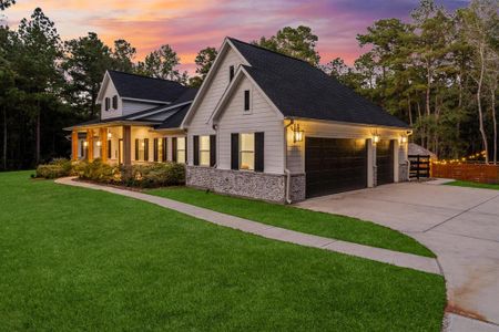 This spacious 4 car oversized garage offers ample room for multiple cars and more. The garage is already plumbed for a water softener and a garage sink.