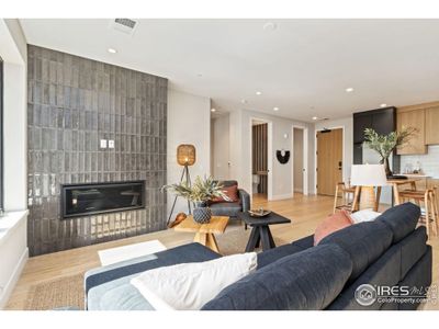 Gas fireplace with gorgeous surround, shiny and mat, soldier stacked tile make for a cozy corner living space.