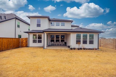 Back of property with stucco siding, a patio, a yard, and a fenced backyard