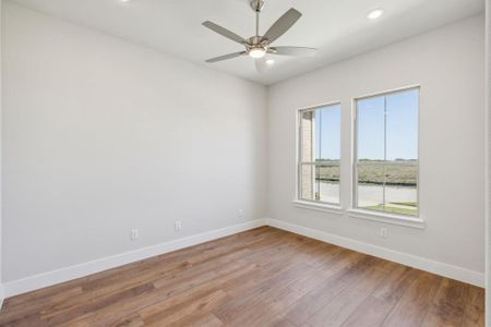 Empty room featuring light hardwood / wood-style floors and ceiling fan