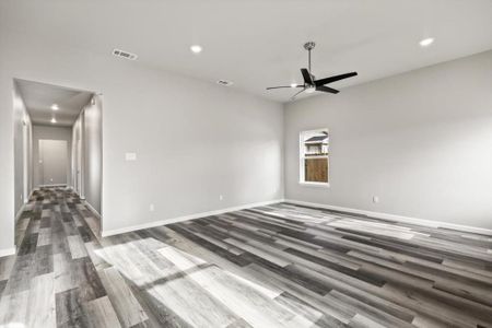 Family room featuring ceiling fan and dark hardwood / wood-style floors