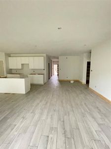 Unfurnished living room featuring light wood-type flooring