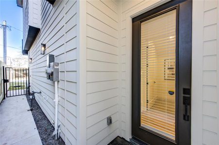 Front door. Side yard is fully fenced and gated for pets to roam freely between backyard and front access gate. Doorbell is at the gate.