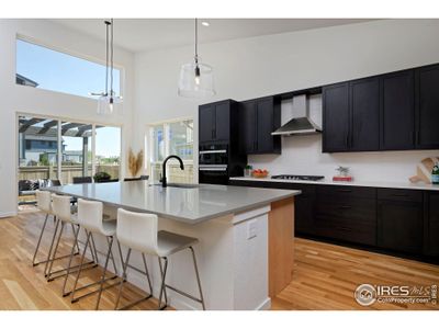 Spacious kitchen with stained and natural Maple shaker style cabinets.