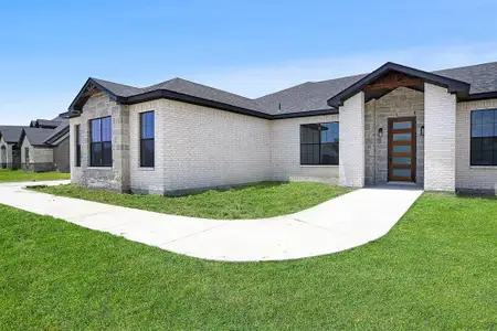 View of property exterior featuring a lawn