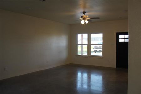 Unfurnished room with ceiling fan and a wealth of natural light