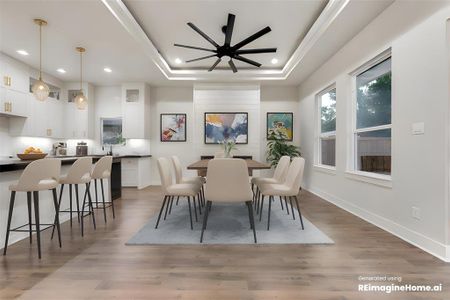 Dining space featuring a tray ceiling, ceiling fan, dark wood-type flooring, and sink