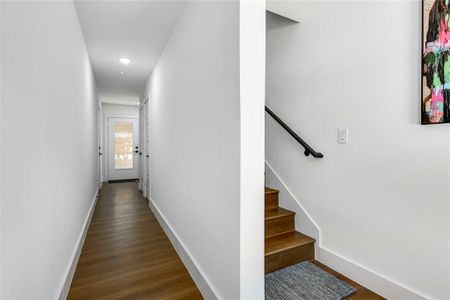 Hallway with dark hardwood / wood-style floors