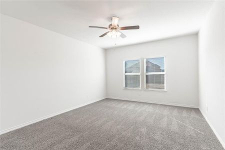 Spare room featuring carpet floors and ceiling fan