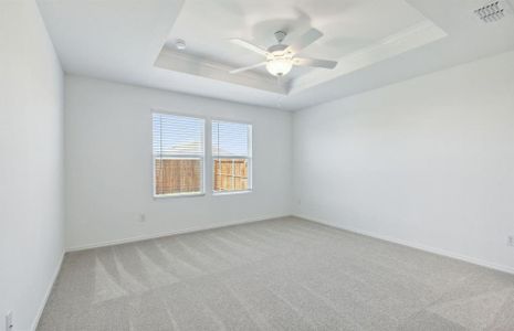 Elegant owner's suite with tray ceiling *real home pictured