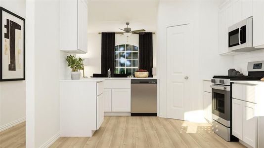 Kitchen featuring light hardwood / wood-style flooring, tasteful backsplash, ceiling fan, white cabinetry, and stainless steel appliances