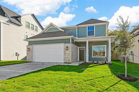 View of front of home featuring a garage and a front lawn