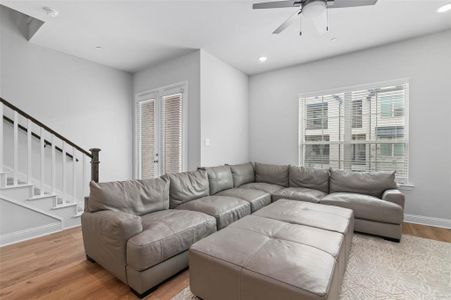 Living room featuring light wood-type flooring and ceiling fan