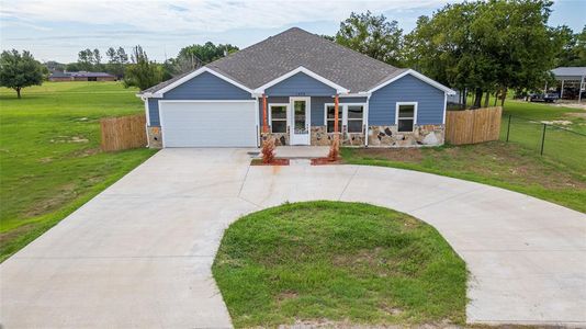 View of front facade with a garage and a front lawn