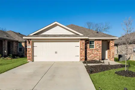 Ranch-style house with a front lawn, concrete driveway, brick siding, and an attached garage