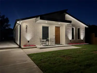 Front View of Home Featuring Accent Lighting