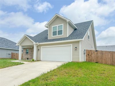 View of front of property with a garage and a front yard