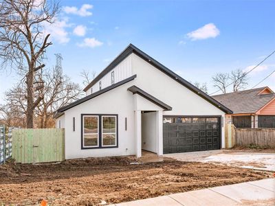 View of front of property featuring a garage