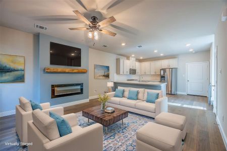 Move in ready living area with celing fan, gas fireplace, window blinds and engineered wood flooring - View