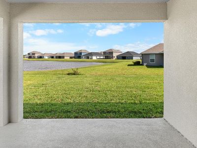 Your living space extends outdoors to a covered lanai, offering peaceful pond views.