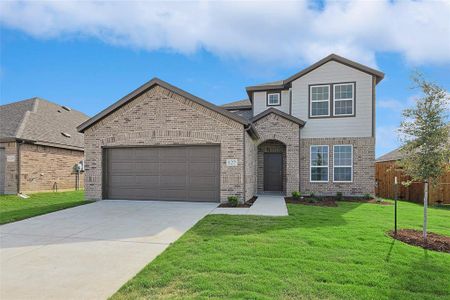 View of front of property with a garage and a front lawn