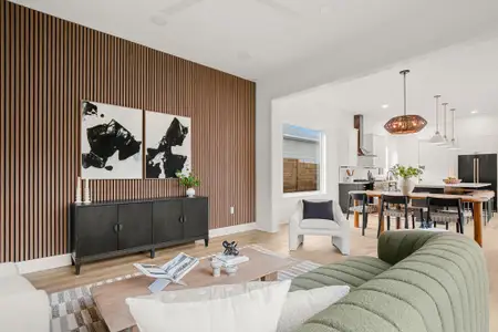 Living area with recessed lighting, light wood-style flooring, and baseboards