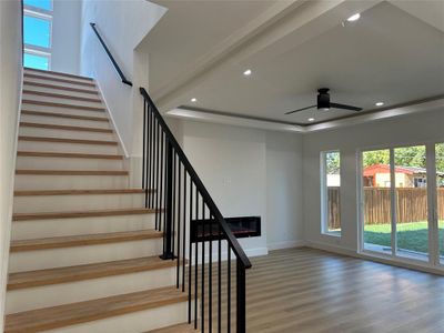 Stairway with ceiling fan and hardwood / wood-style flooring