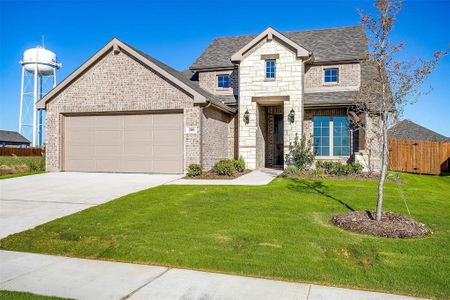 View of front of home featuring a front yard and a garage